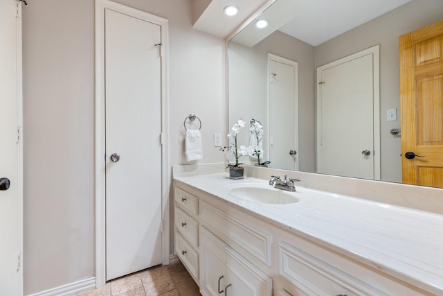8907 Meadowknoll Dr, Dallas, TX 75243 - bathroom featuring vanity, stone tile floors, and recessed lighting