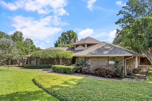 8907 Meadowknoll Dr, Dallas, TX 75243 - view of front of house featuring a chimney, a shingled roof, and brick siding