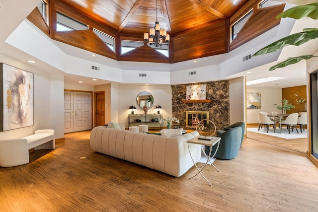 8907 Meadowknoll Dr, Dallas, TX 75243 - living room featuring a towering ceiling, wood finished floors, a chandelier, wooden ceiling, and a fireplace