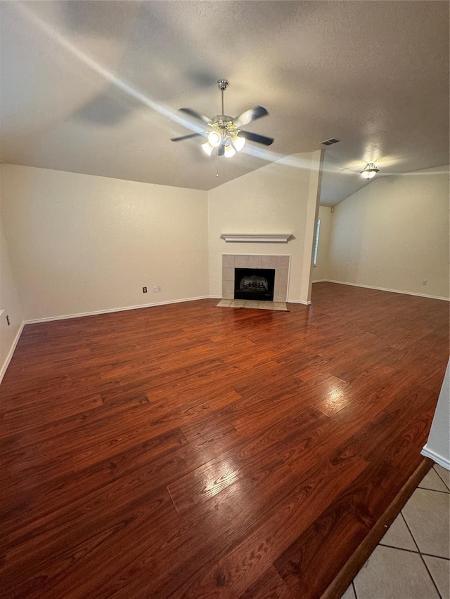 836 Cedar Ridge Ln, Burleson, TX 76028 - unfurnished living room featuring a ceiling fan, a fireplace, lofted ceiling, wood finished floors, and baseboards