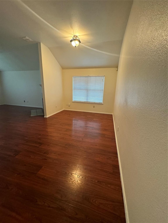 836 Cedar Ridge Ln, Burleson, TX 76028 - unfurnished room with lofted ceiling, dark wood-type flooring, and baseboards