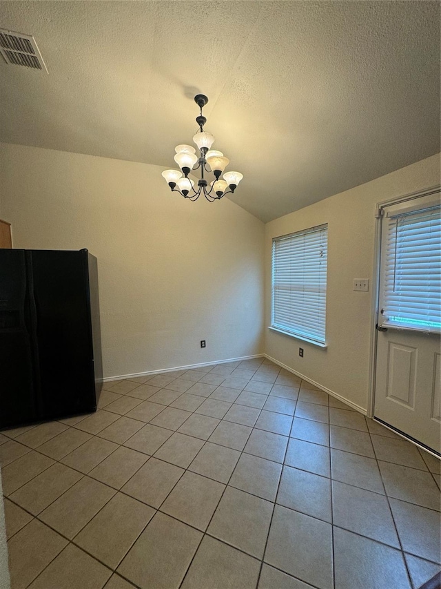836 Cedar Ridge Ln, Burleson, TX 76028 - unfurnished dining area with vaulted ceiling, a chandelier, light tile patterned floors, a textured ceiling, and healthy amount of natural light