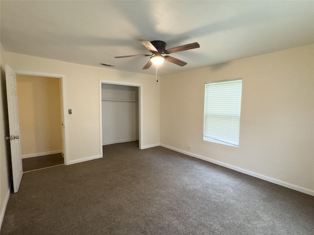 921 Longino St, Sulphur Springs, TX 75482 - unfurnished bedroom with a closet, dark carpet, baseboards, and a ceiling fan