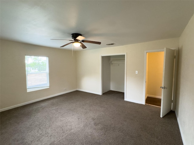 921 Longino St, Sulphur Springs, TX 75482 - unfurnished bedroom with dark colored carpet, baseboards, ceiling fan, and a closet