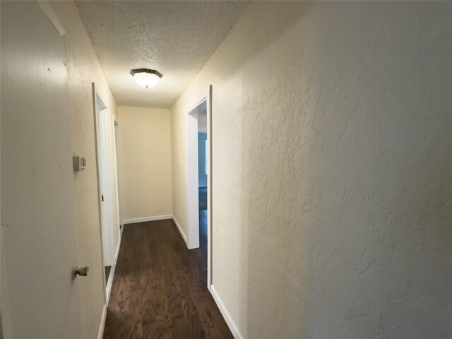 921 Longino St, Sulphur Springs, TX 75482 - hallway with a textured ceiling, wood finished floors, and baseboards