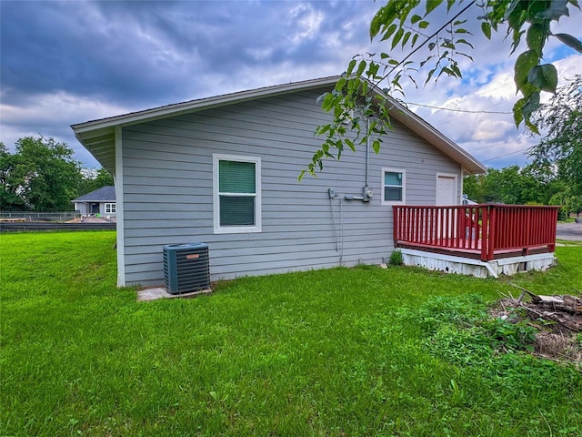 921 Longino St, Sulphur Springs, TX 75482 - back of house with a wooden deck, cooling unit, and a lawn