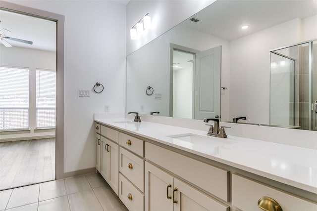 135 Claire Dr, Trophy Club, TX 76262 - full bathroom with a ceiling fan, double vanity, a shower with shower door, baseboards, and tile patterned flooring