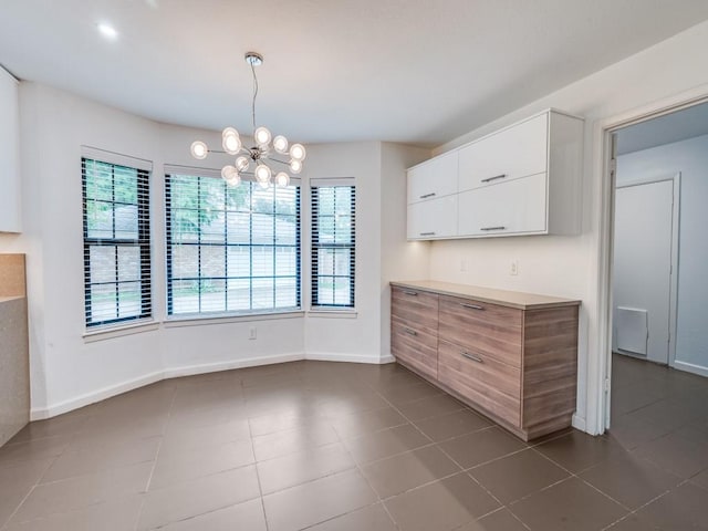 3414 Country Club Rd, Pantego, TX 76013 - kitchen featuring a chandelier, white cabinets, light countertops, baseboards, and hanging light fixtures