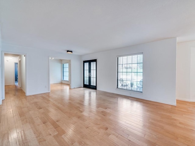 3414 Country Club Rd, Pantego, TX 76013 - unfurnished living room featuring light wood-style flooring and baseboards