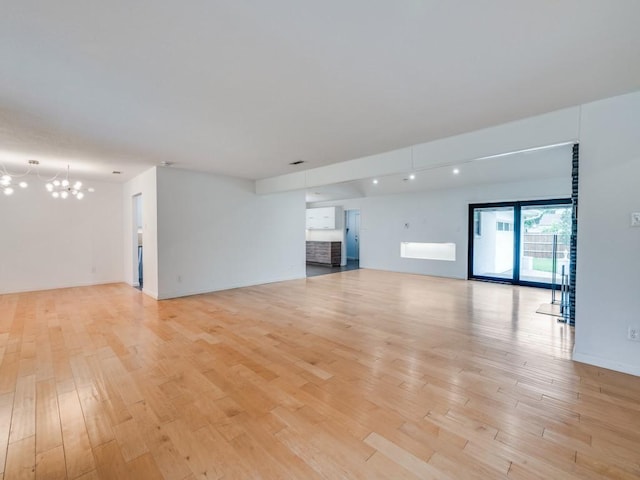 3414 Country Club Rd, Pantego, TX 76013 - unfurnished living room featuring a chandelier, light wood-style flooring, and baseboards