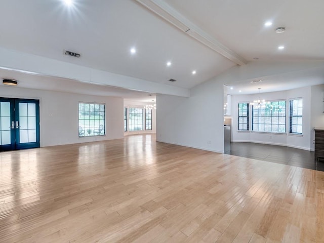 3414 Country Club Rd, Pantego, TX 76013 - unfurnished living room with a chandelier, light wood-type flooring, healthy amount of natural light, recessed lighting, and french doors