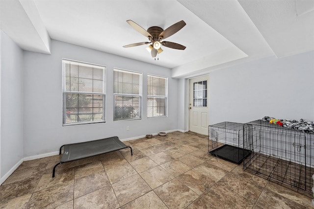 22 Buttercup Cir, Waco, TX 76708 - spare room featuring a ceiling fan, baseboards, and stone finish floors