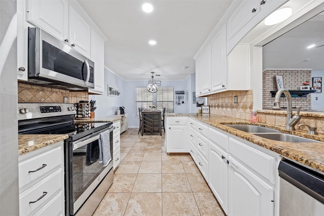 22 Buttercup Cir, Waco, TX 76708 - kitchen featuring appliances with stainless steel finishes, a sink, decorative backsplash, white cabinets, and recessed lighting