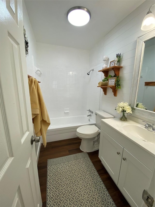 4313 Windsor Dr, Garland, TX 75042 - bathroom featuring wood finished floors, vanity, shower / bath combination, and toilet
