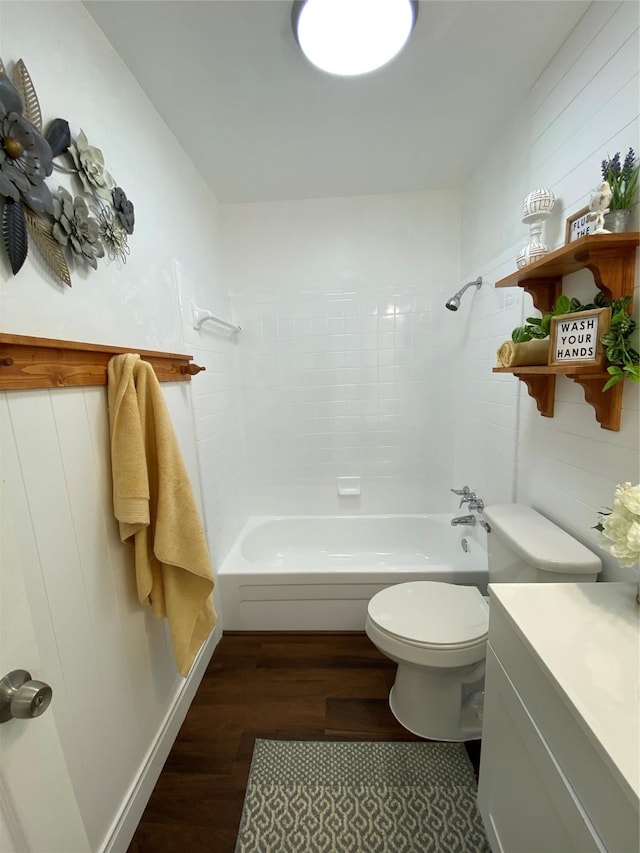 4313 Windsor Dr, Garland, TX 75042 - bathroom with wood finished floors, toilet, washtub / shower combination, and vanity