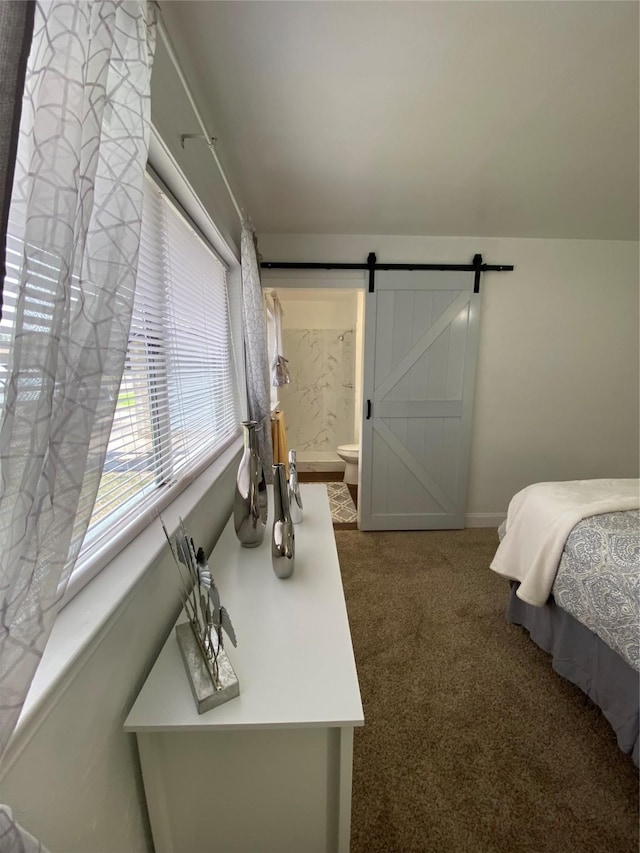 4313 Windsor Dr, Garland, TX 75042 - carpeted bedroom with baseboards, ensuite bathroom, and a barn door