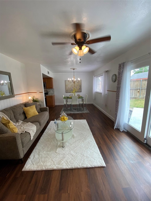 4313 Windsor Dr, Garland, TX 75042 - living room with a chandelier, a ceiling fan, wainscoting, and dark wood-type flooring