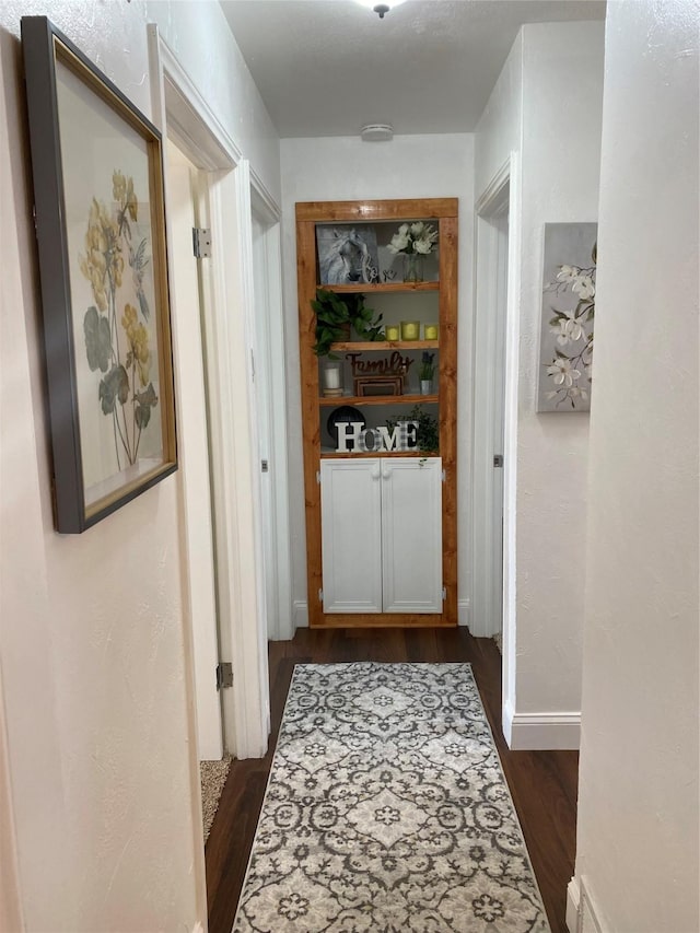 4313 Windsor Dr, Garland, TX 75042 - corridor featuring dark wood-type flooring and baseboards