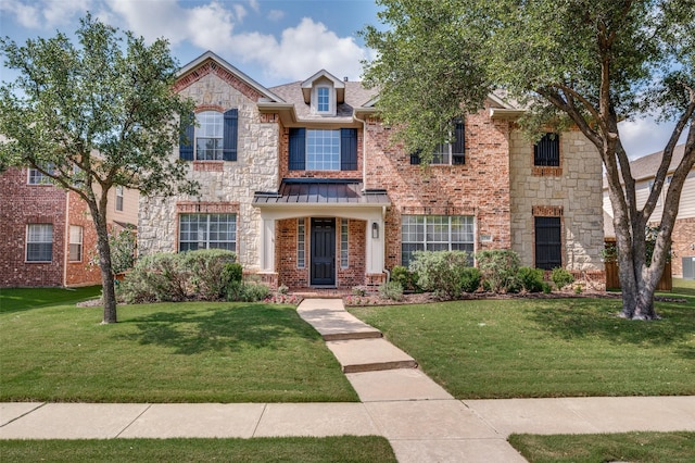 2750 Bandolier Ln, Frisco, TX 75033 - view of front of house with a front yard, a standing seam roof, and stone siding