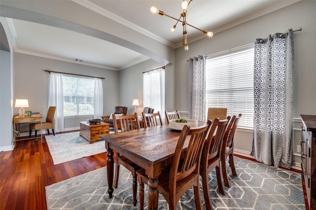 2750 Bandolier Ln, Frisco, TX 75033 - dining area featuring arched walkways, wood finished floors, ornamental molding, baseboards, and a chandelier