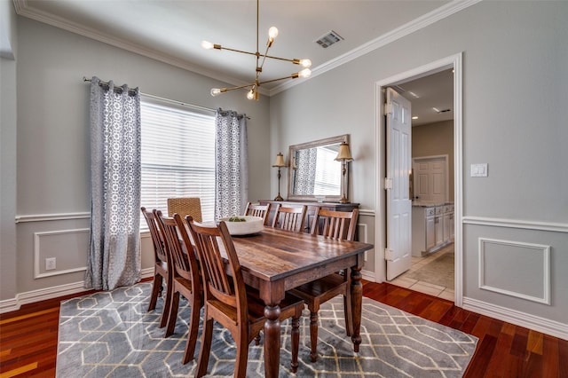 2750 Bandolier Ln, Frisco, TX 75033 - dining room with a chandelier, crown molding, wood finished floors, and baseboards