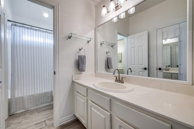 2750 Bandolier Ln, Frisco, TX 75033 - bathroom featuring vanity, wood finished floors, and curtained shower