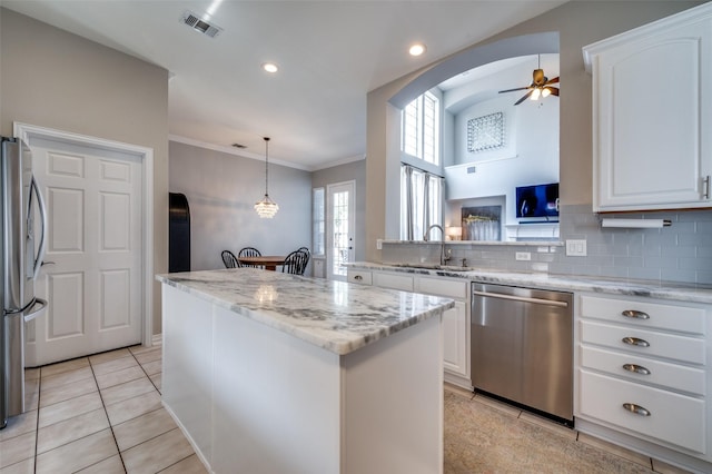 2750 Bandolier Ln, Frisco, TX 75033 - kitchen featuring stainless steel appliances, a sink, ceiling fan, a center island, and light tile patterned flooring