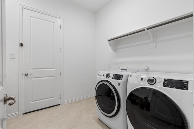 8509 Barnbougle Dunes Dr, Mckinney, TX 75070 - laundry room with washing machine and clothes dryer, baseboards, and light tile patterned floors