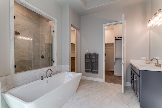 518 Syracuse St, Haslet, TX 76052 - bathroom featuring a walk in closet, a shower stall, vanity, a soaking tub, and marble look tile flooring