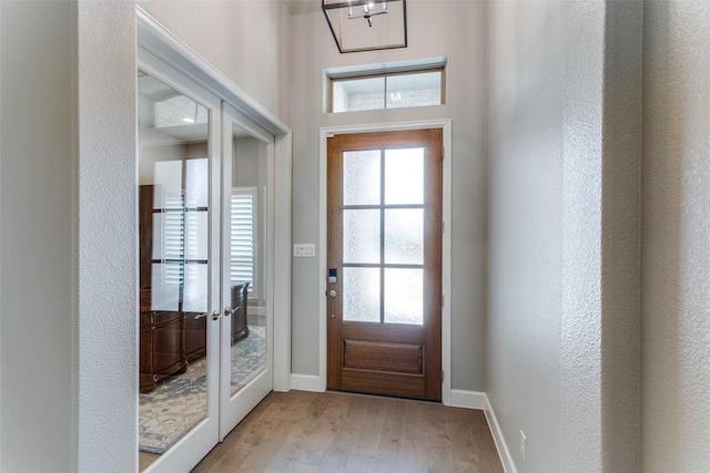 518 Syracuse St, Haslet, TX 76052 - entrance foyer featuring light wood-type flooring, healthy amount of natural light, a chandelier, baseboards, and a textured wall