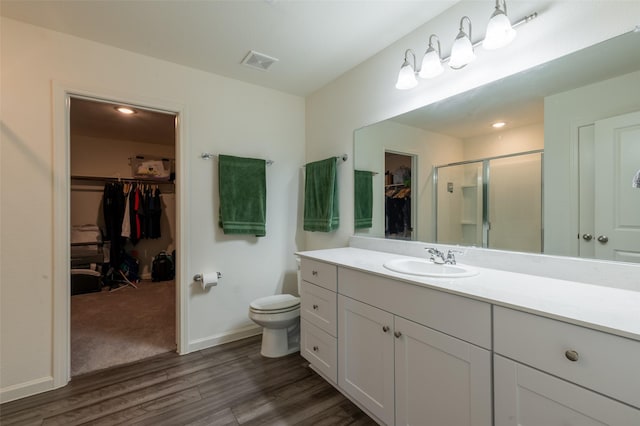 1401 Ancer Way, Fort Worth, TX 76052 - full bath featuring a spacious closet, vanity, wood finished floors, a shower stall, and toilet