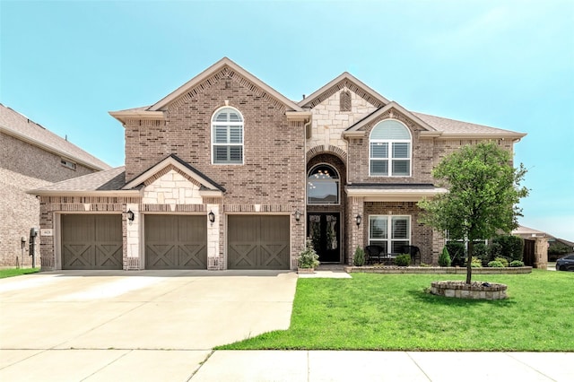 4426 Mineral Creek Trl, Celina, TX 75078 - view of front facade featuring brick siding, a front yard, driveway, and stone siding