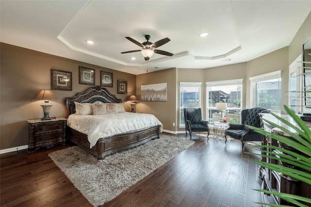 4426 Mineral Creek Trl, Celina, TX 75078 - bedroom featuring a raised ceiling, baseboards, recessed lighting, dark wood-style flooring, and a ceiling fan