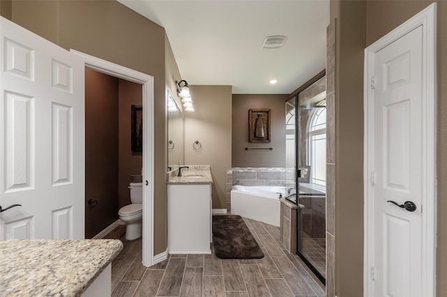 4426 Mineral Creek Trl, Celina, TX 75078 - bathroom with vanity, a bath, toilet, a stall shower, and wood finish floors