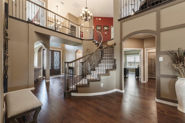 4426 Mineral Creek Trl, Celina, TX 75078 - foyer entrance with arched walkways, a towering ceiling, hardwood / wood-style flooring, stairway, and baseboards