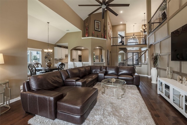 4426 Mineral Creek Trl, Celina, TX 75078 - living area with a chandelier, arched walkways, a ceiling fan, dark wood-type flooring, and high vaulted ceiling