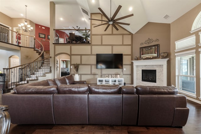 4426 Mineral Creek Trl, Celina, TX 75078 - living room with high vaulted ceiling, ceiling fan, a fireplace, stairs, and a chandelier