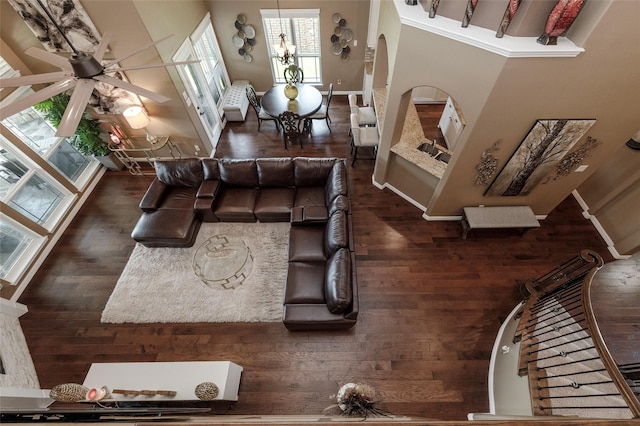 4426 Mineral Creek Trl, Celina, TX 75078 - living room with baseboards, arched walkways, wood finished floors, and ceiling fan