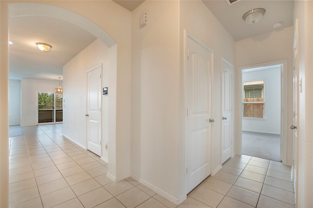 2154 Slow Stream Dr, Royse City, TX 75189 - hallway featuring arched walkways, light tile patterned floors, and baseboards