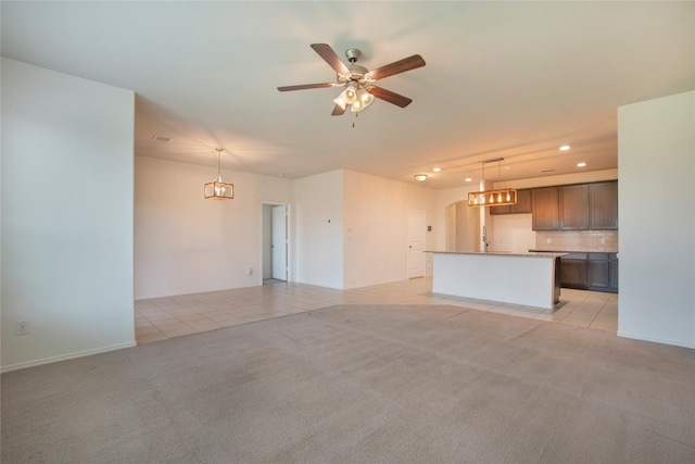 2154 Slow Stream Dr, Royse City, TX 75189 - unfurnished living room with recessed lighting, ceiling fan, light colored carpet, light tile patterned flooring, and arched walkways