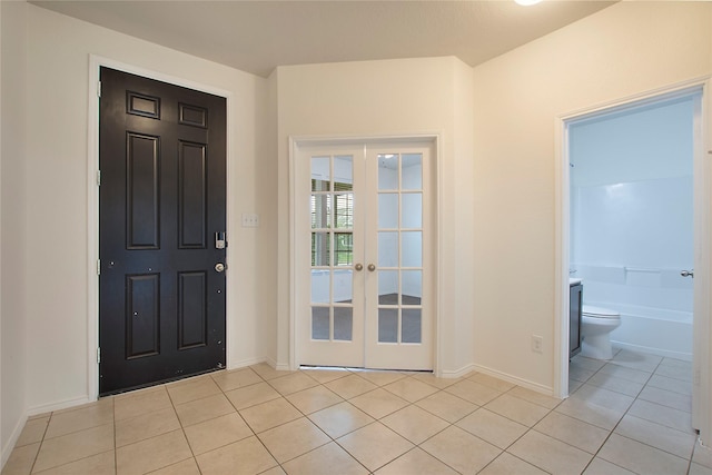 2154 Slow Stream Dr, Royse City, TX 75189 - foyer entrance with french doors, light tile patterned floors, and baseboards
