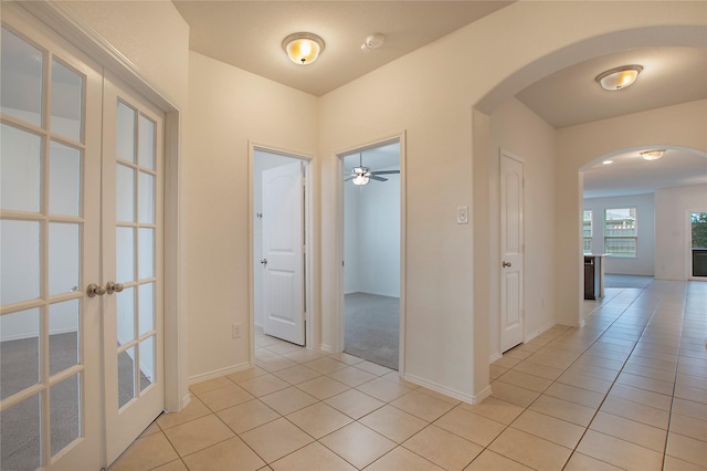 2154 Slow Stream Dr, Royse City, TX 75189 - corridor featuring arched walkways, light tile patterned floors, french doors, and baseboards