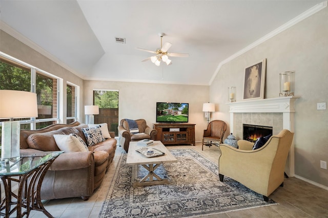 5312 Timber Park Dr, Flower Mound, TX 75028 - living area featuring lofted ceiling, light tile patterned floors, ceiling fan, a tile fireplace, and crown molding