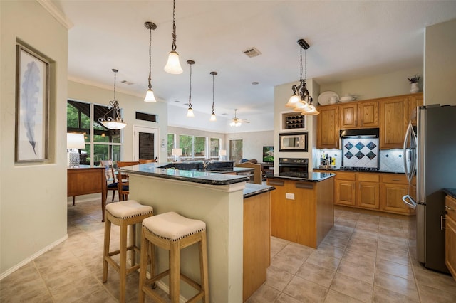 5312 Timber Park Dr, Flower Mound, TX 75028 - kitchen featuring a kitchen island, stainless steel appliances, backsplash, a ceiling fan, and light tile patterned floors