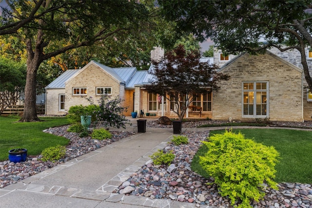 530 Rolling Hills Rd, Coppell, TX 75019 - view of front of property with a standing seam roof, a front yard, stone siding, a chimney, and a porch
