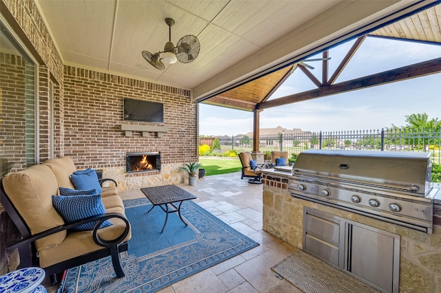 7617 Windsor, The Colony, TX 75056 - view of patio with an outdoor brick fireplace and a ceiling fan