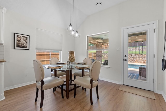 8228 Shady Valley Dr, Benbrook, TX 76116 - dining room featuring light wood-style flooring, vaulted ceiling, and baseboards