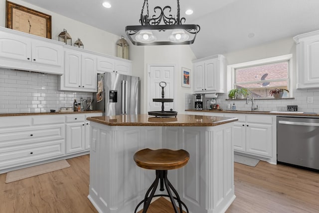 8228 Shady Valley Dr, Benbrook, TX 76116 - kitchen with stainless steel appliances, a kitchen island, tasteful backsplash, a kitchen breakfast bar, and recessed lighting
