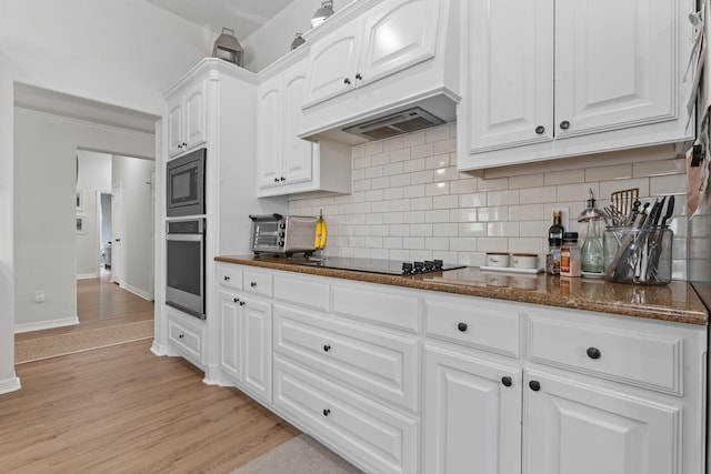 8228 Shady Valley Dr, Benbrook, TX 76116 - kitchen with stainless steel appliances, white cabinetry, decorative backsplash, dark stone counters, and custom exhaust hood