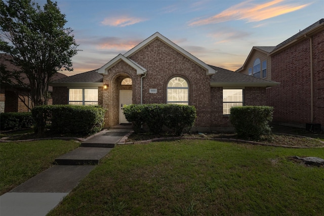 5809 Hidden Pine Ln, Mckinney, TX 75070 - view of front facade featuring brick siding, a yard, and a shingled roof